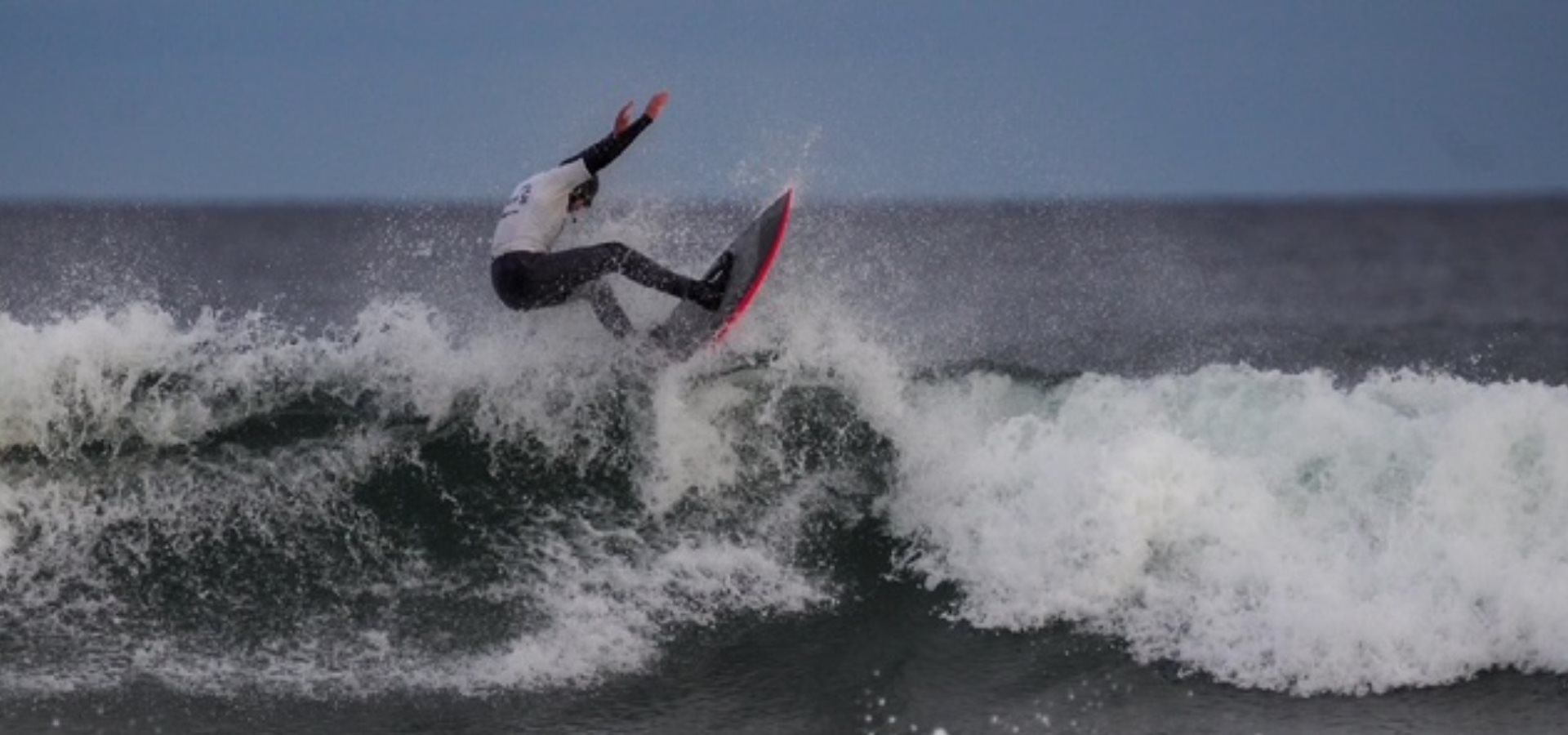Aidan surfing in the sea