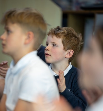 three children singing, clapping, enthralled