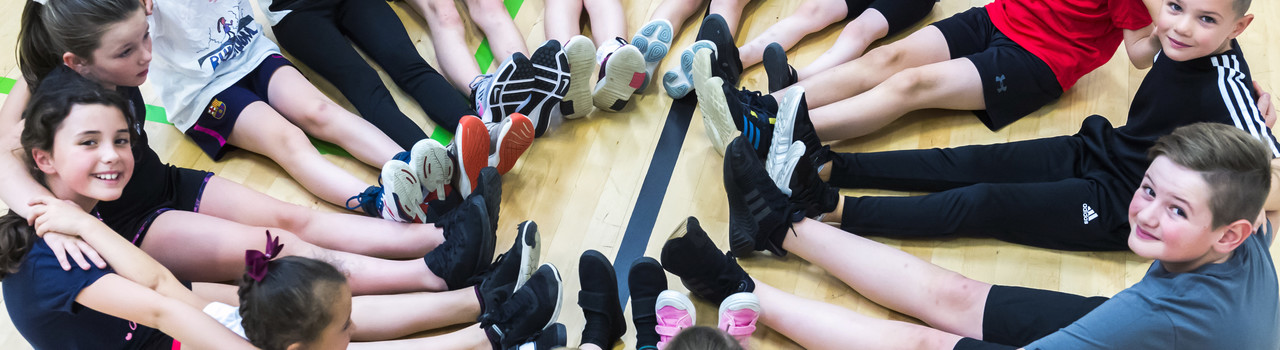 Circle of children with feet linked together