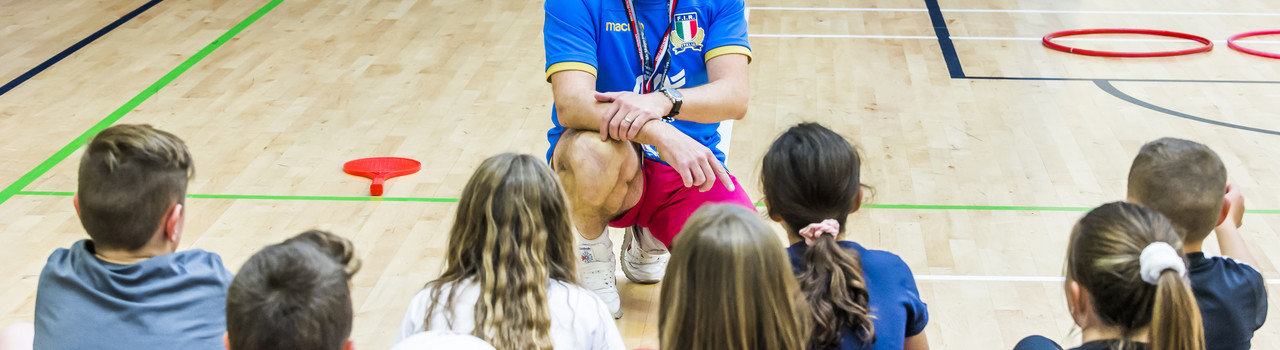 sport coach teaching children