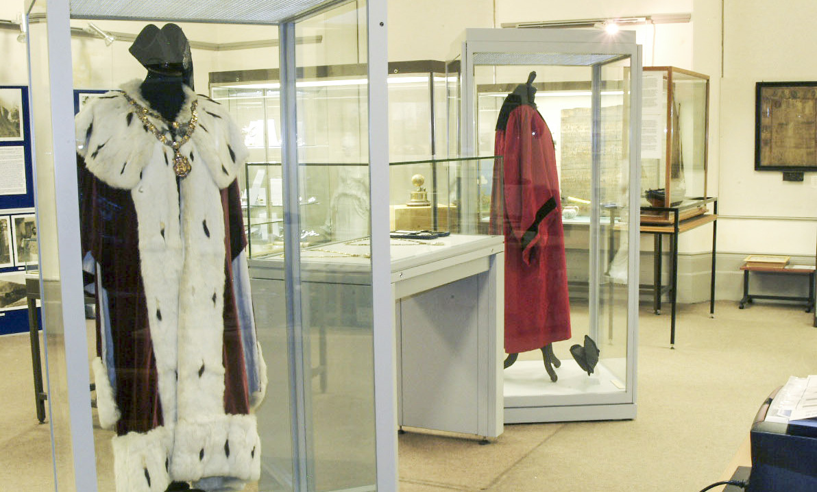 inside view of Banff Museum showing some costumes in cases