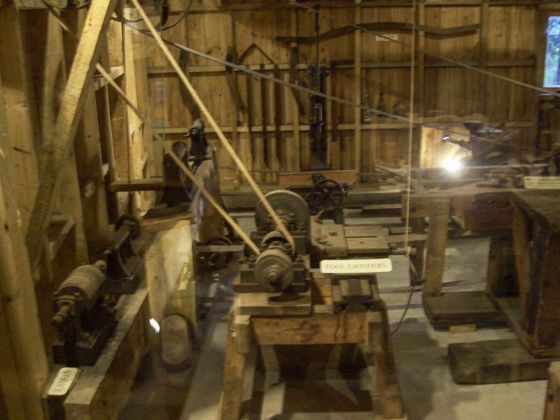 Interior view of workshop with large belt driven tools. 