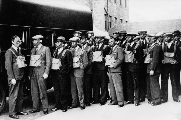 Group of men wearing their issued gas masks for gas mask practice