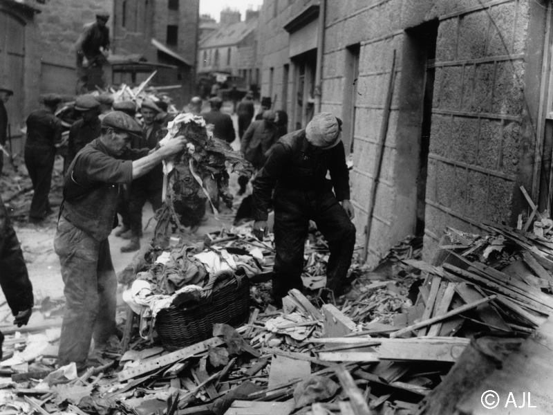Civilians and workmen sift through the debris after a bombing raid on Peterhead on 28th or 29th September 1941