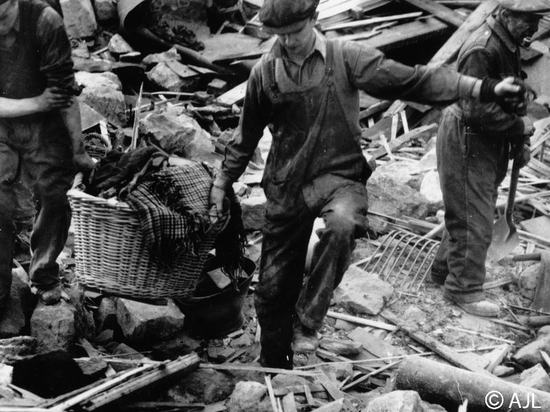 A second image of civilians and workmen sift through the debris after a bombing raid on Peterhead on 28th or 29th September 1941