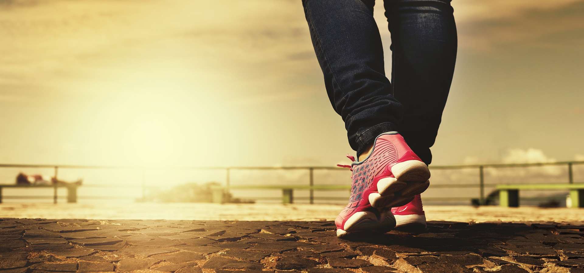 A person walking as the sun sets