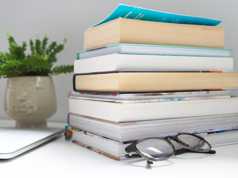 A bundle of books on a table ready to be read