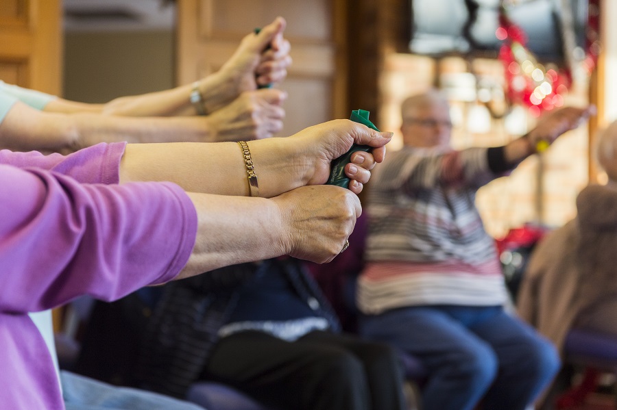 Image shows people participating in a gentle exercise class.