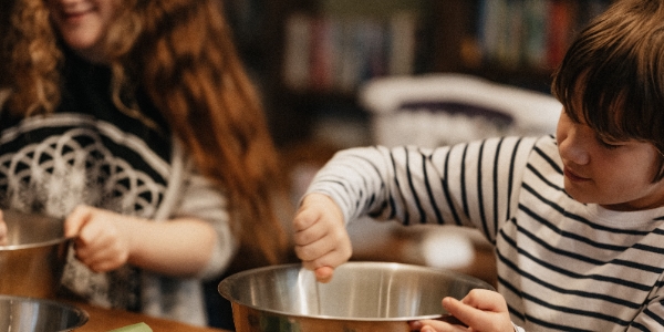 A boy and girl mixing ingredients in a bowl