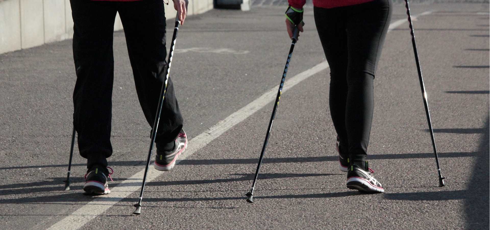 Two people walking with nordic walking poles