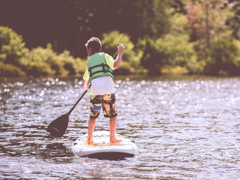 A young person standing on a paddleboard