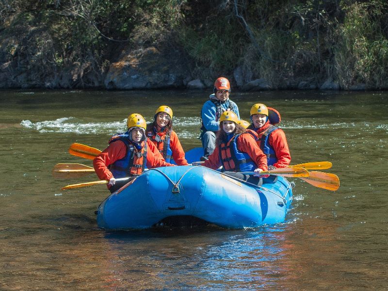 A group of people out on the water on a raft