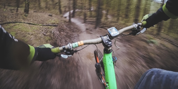 A person mountain biking down a hill