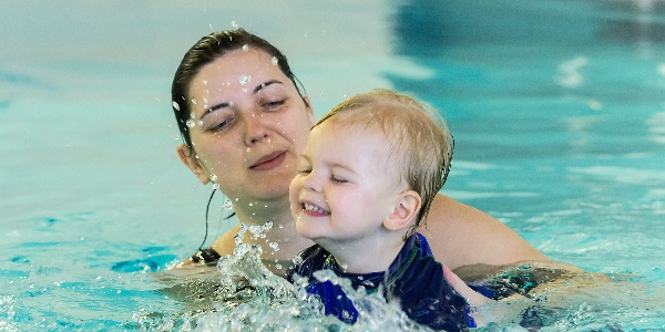 An adult and baby enjoying a swimming lesson