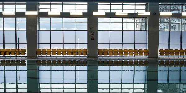 A group of children holding floats in the swimming pool