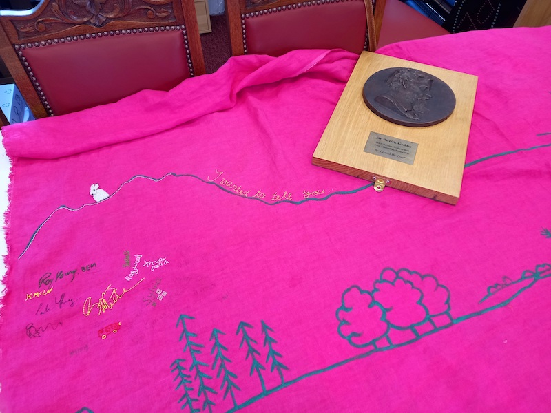 Patrick Geddes plaque on top of pink cloth