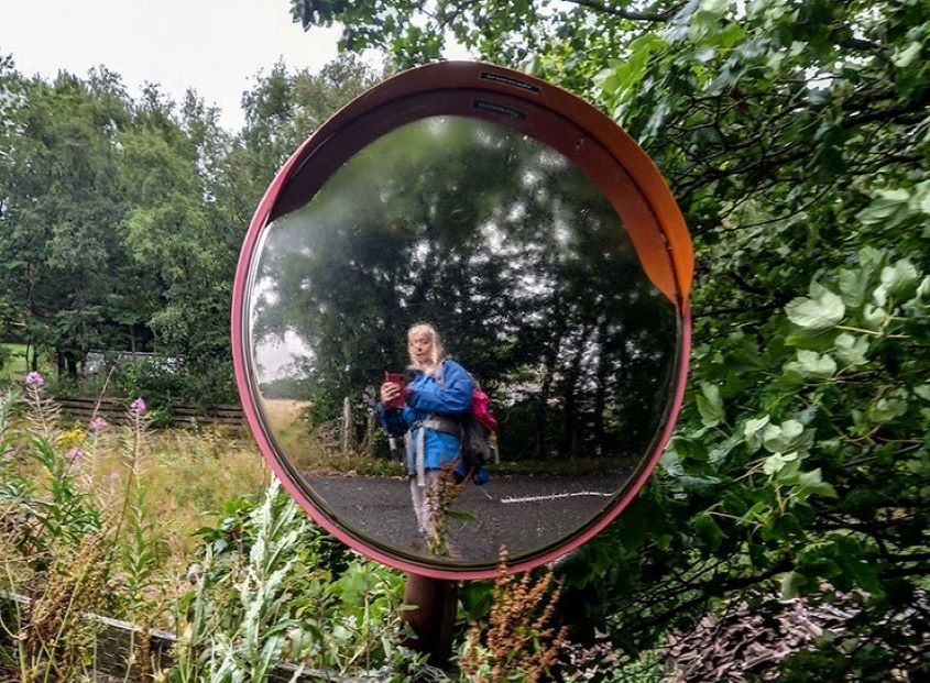 artist selfie on round street mirror