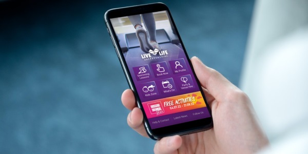 a person holding a mobile phone with the Live Life Aberdeenshire app