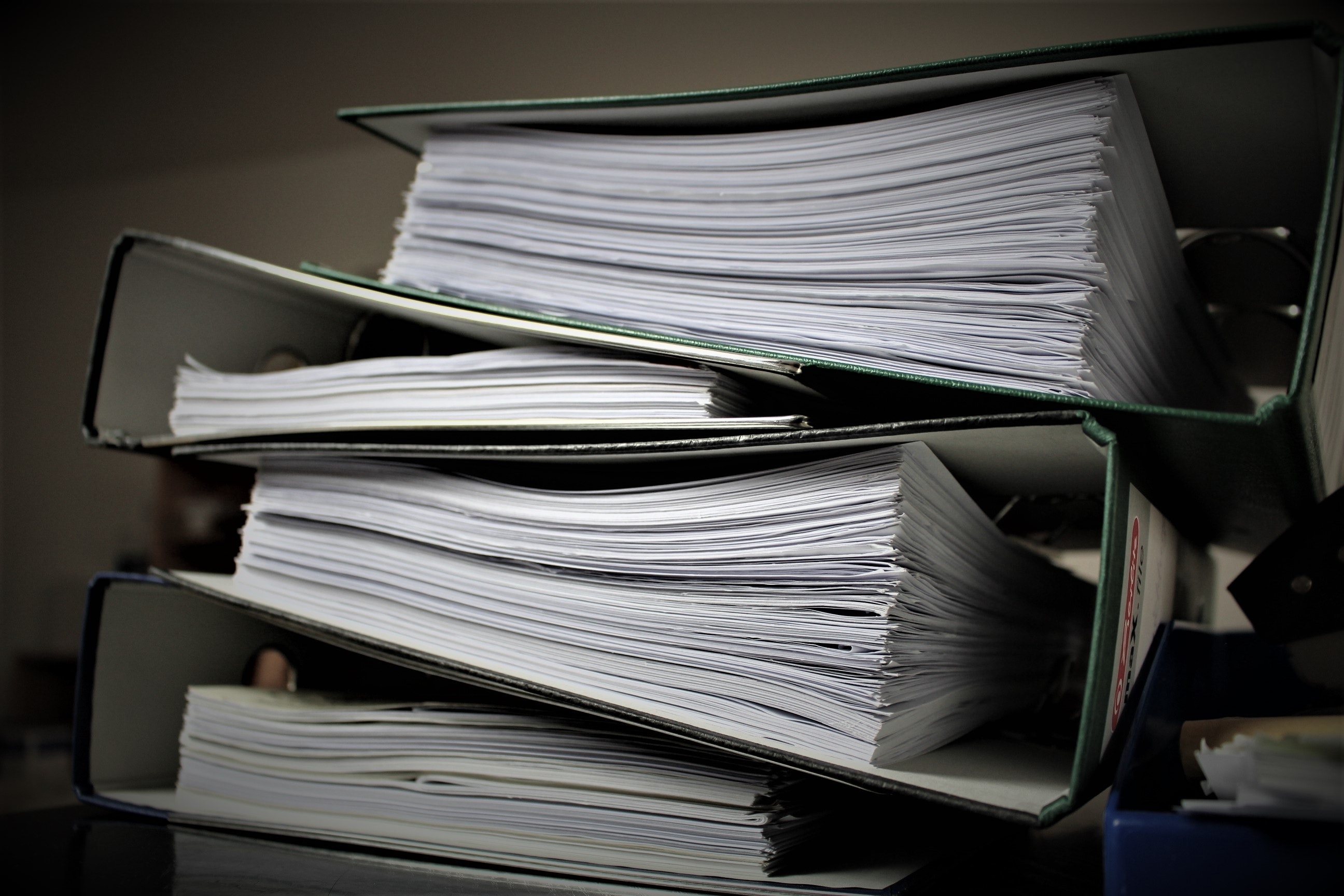 Four ring binder folders stacked on top of each other