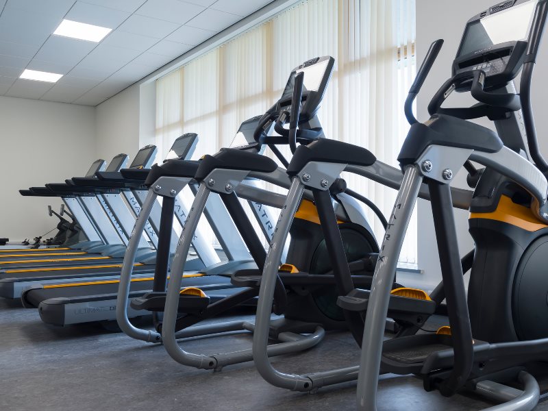 A row of exercise bikes and spin machines