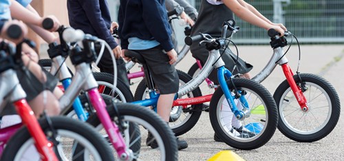 a line up balance bikes in different colours